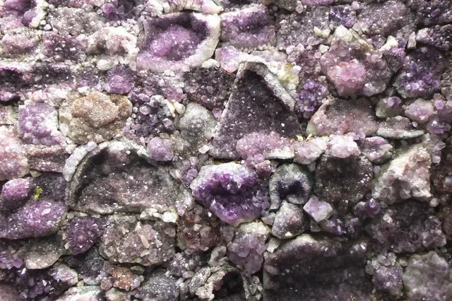 Amethyst — Wall built from purple amethyst geodes and crystal clusters
